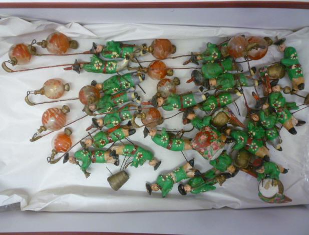 Twenty four Chinese papier mache hand painted figures in green robes and black hats Image