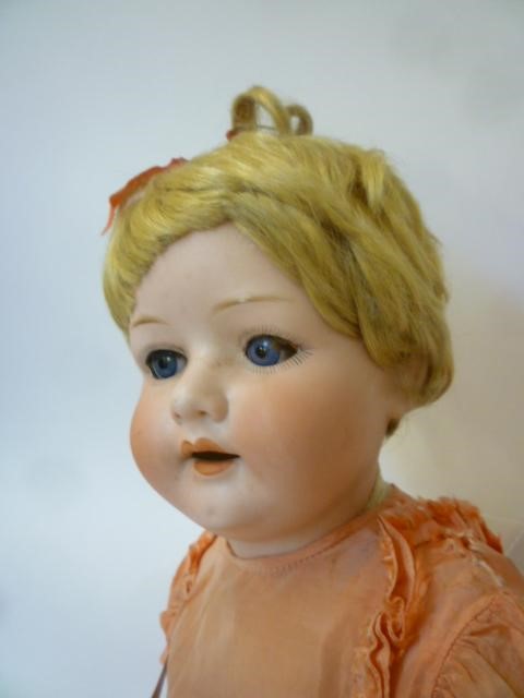 An Ernst Heubach bisque head character doll with blue glass sleeping eyes Image