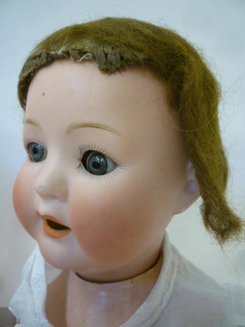 An Ernst Heubach bisque head character doll with blue glass sleeping eyes Image