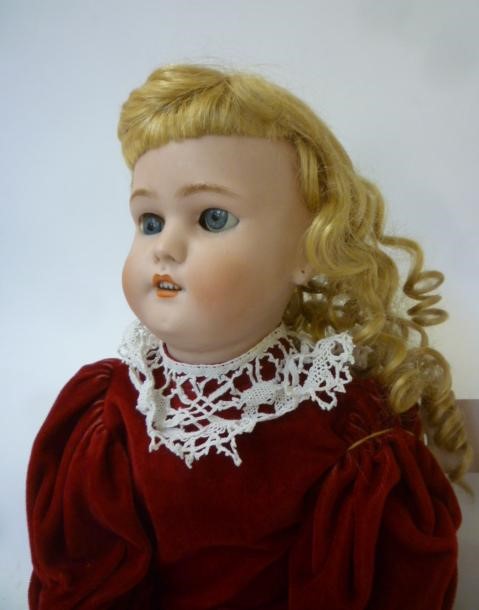 A Simon & Halbig bisque head doll with blue glass sleeping eyes Image