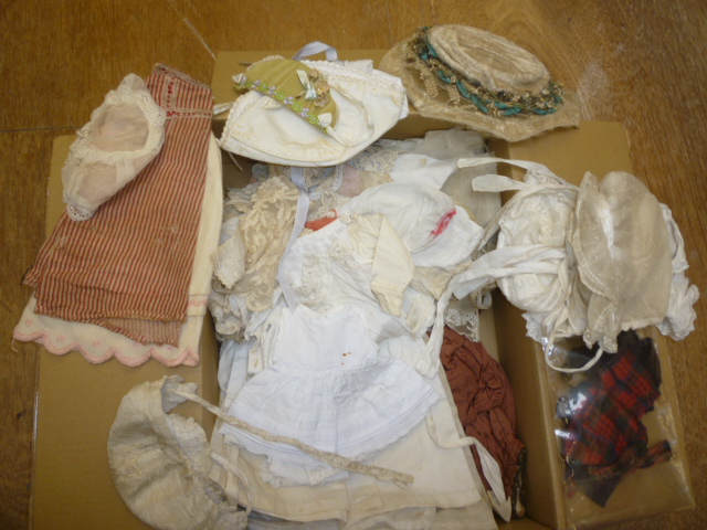 A quantity of early 20th century dolls' clothing including dresses Image