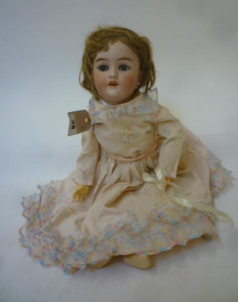 A Heinrich Handwerck bisque head doll with blue glass sleeping eyes Image