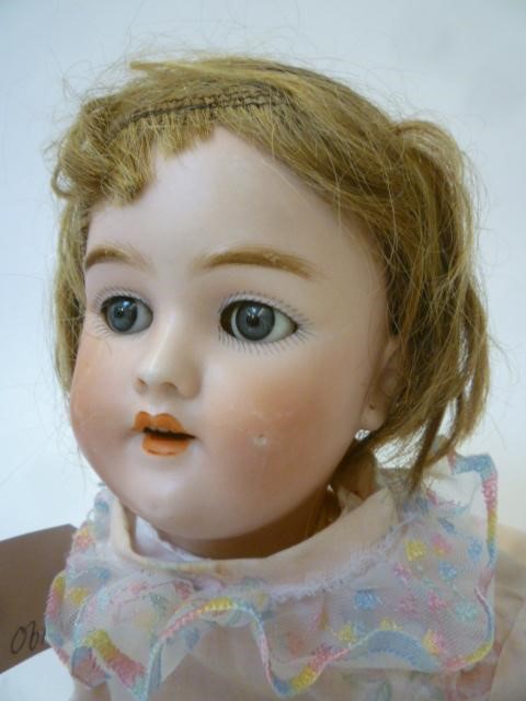 A Heinrich Handwerck bisque head doll with blue glass sleeping eyes Image