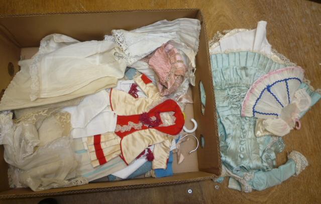 A large quantity of doll's vintage dresses and other clothing in silk Image