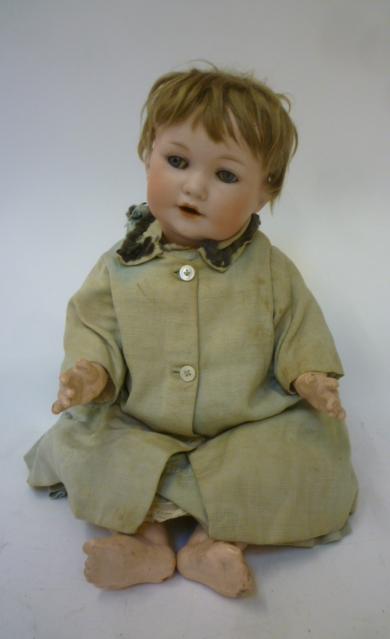 An Armand Marseille bisque head character doll with blue glass sleeping eyes Image