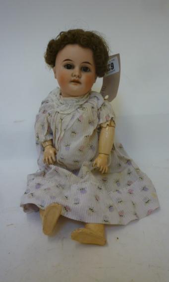 A Gebruder Kuhnlenz bisque head doll with brown sleeping glass eyes Image