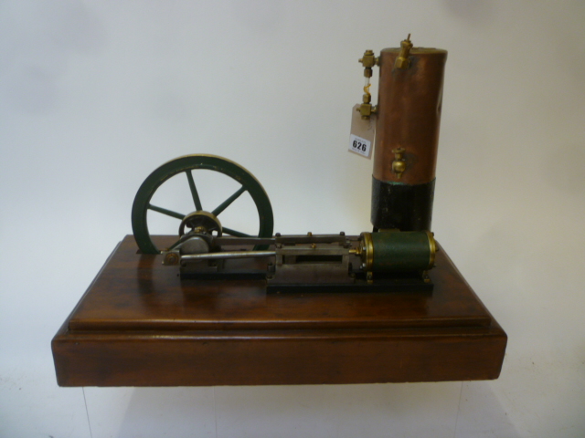 A single cylinder horizontal steam engine in brass and steel with 6 3/4" fly wheels and vertical Image