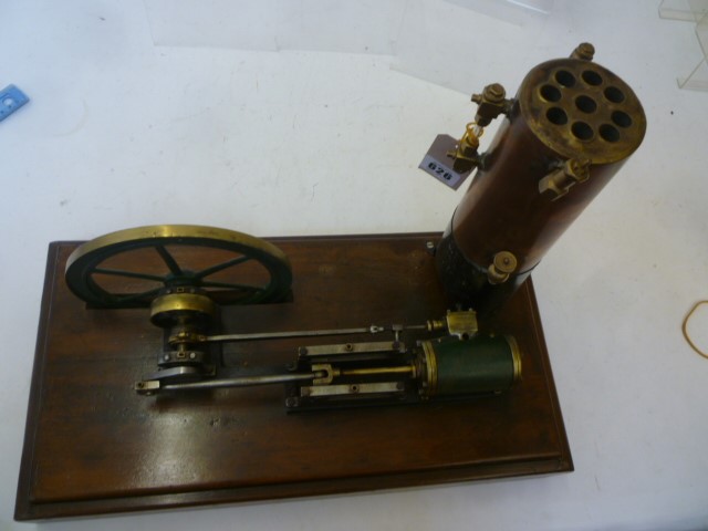 A single cylinder horizontal steam engine in brass and steel with 6 3/4" fly wheels and vertical Image