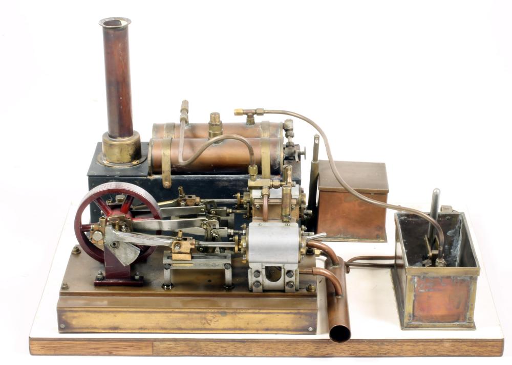 A twin cylinder horizontal steam engine in brass and steel with flywheel Image