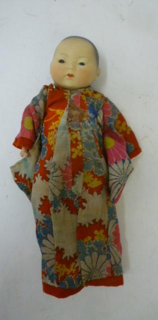 An Armand Marseille bisque head oriental baby doll with brown glass sleeping eyes Image