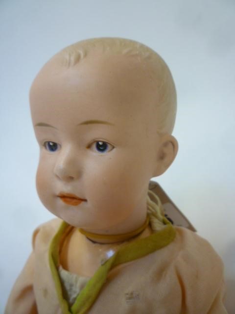 A Gebruder Heubach "Solemn Boy" bisque head doll with painted face Image