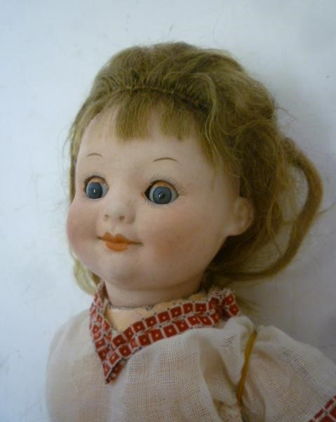 An Armand Marseille bisque head google eyed character doll with blue glass sleeping eyes Image