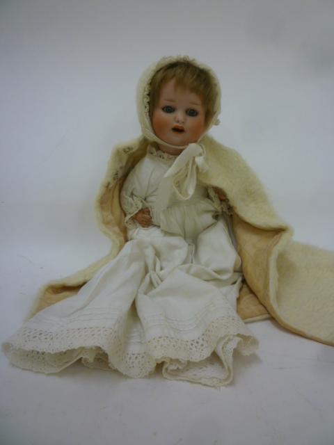 An Ernst Heubach bisque head doll with blue glass sleeping eyes Image