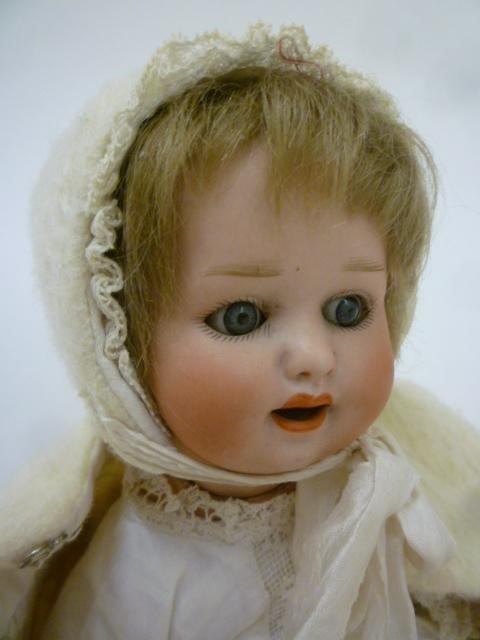 An Ernst Heubach bisque head doll with blue glass sleeping eyes Image