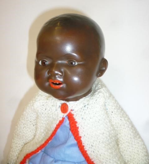 An Armand Marseille bisque head black baby doll with brown glass sleeping eyes Image
