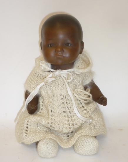 An Armand Marseille bisque head black baby doll with brown glass sleeping eyes Image