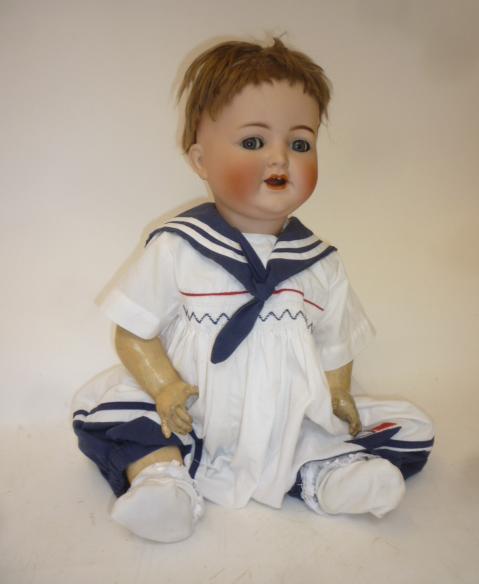 A Kammer & Reinhardt bisque head character doll with blue glass flirty eyes Image