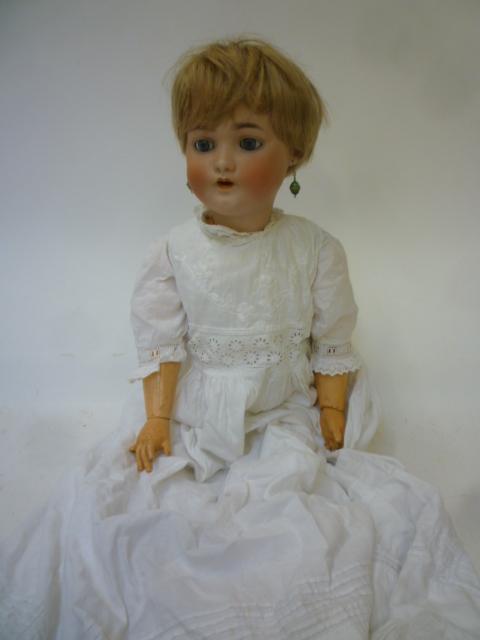 A Franz Schmidt & Co bisque head doll with blue glass sleeping eyes Image