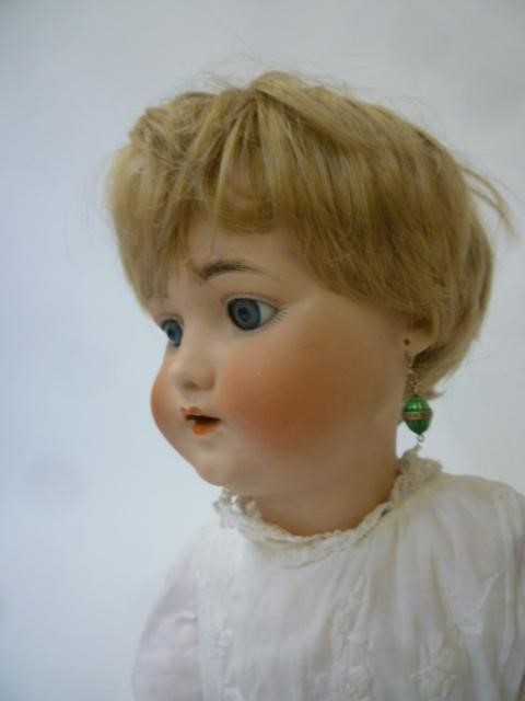 A Franz Schmidt & Co bisque head doll with blue glass sleeping eyes Image
