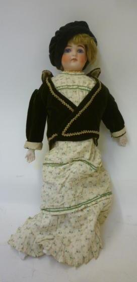 A bisque shoulder head Belton type doll with fixed blue glass eyes Image
