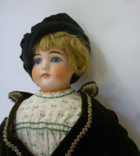 A bisque shoulder head Belton type doll with fixed blue glass eyes Image