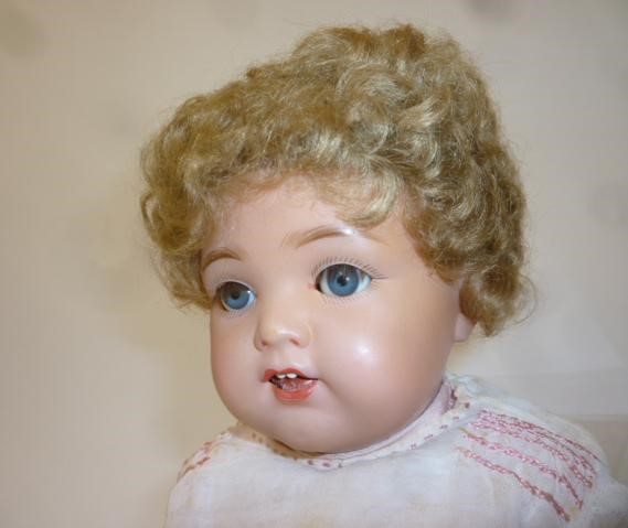 A Kammer & Reinhardt celluloid head character doll with blue glass flirty eyes Image