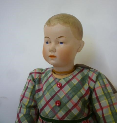 A Hertel Schwab & Co bisque head doll with painted face and hair Image