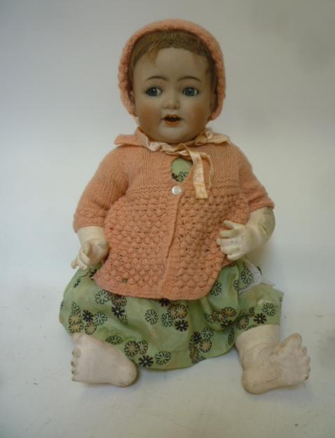 A Kammer & Reinhardt bisque head character doll with blue glass flirty eyes Image