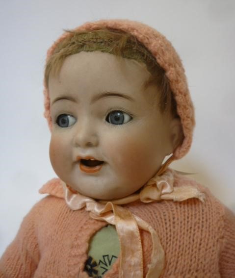 A Kammer & Reinhardt bisque head character doll with blue glass flirty eyes Image
