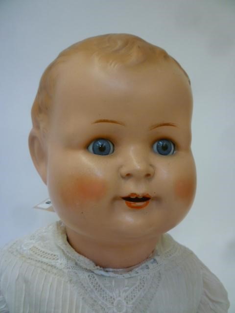 A German all bisque doll with blue glass sleeping eyes Image