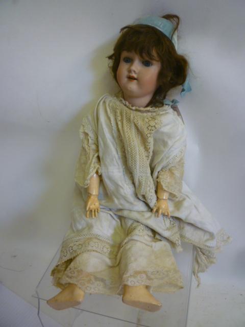 A Max Handwerck bisque head doll with blue glass sleeping eyes Image