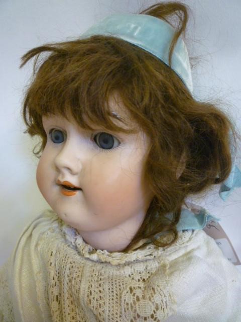 A Max Handwerck bisque head doll with blue glass sleeping eyes Image