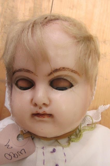 A wax covered shoulder head doll with blue glass sleeping eyes Image