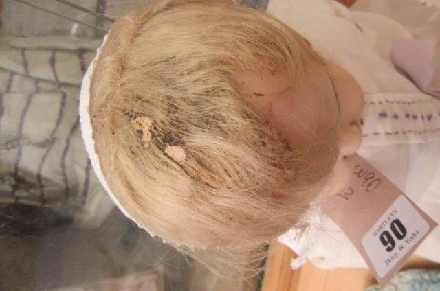 A wax covered shoulder head doll with blue glass sleeping eyes Image