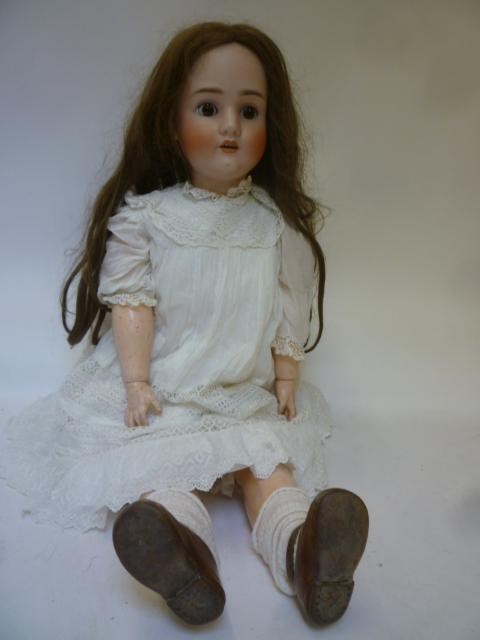 A large Schoenau & Hofmeister bisque head doll with brown glass sleeping eyes Image