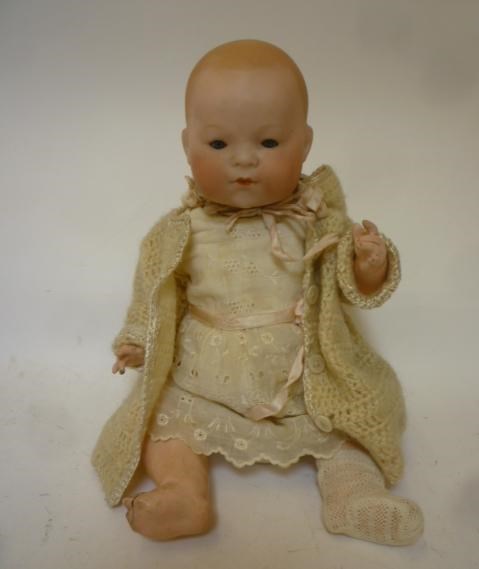 An Ernst Heubach bisque head baby doll with blue glass sleeping eyes Image