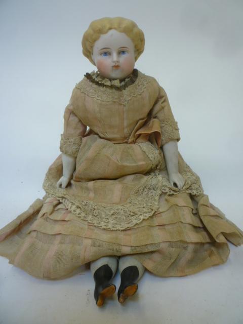 A parian china shoulder head doll with painted face Image