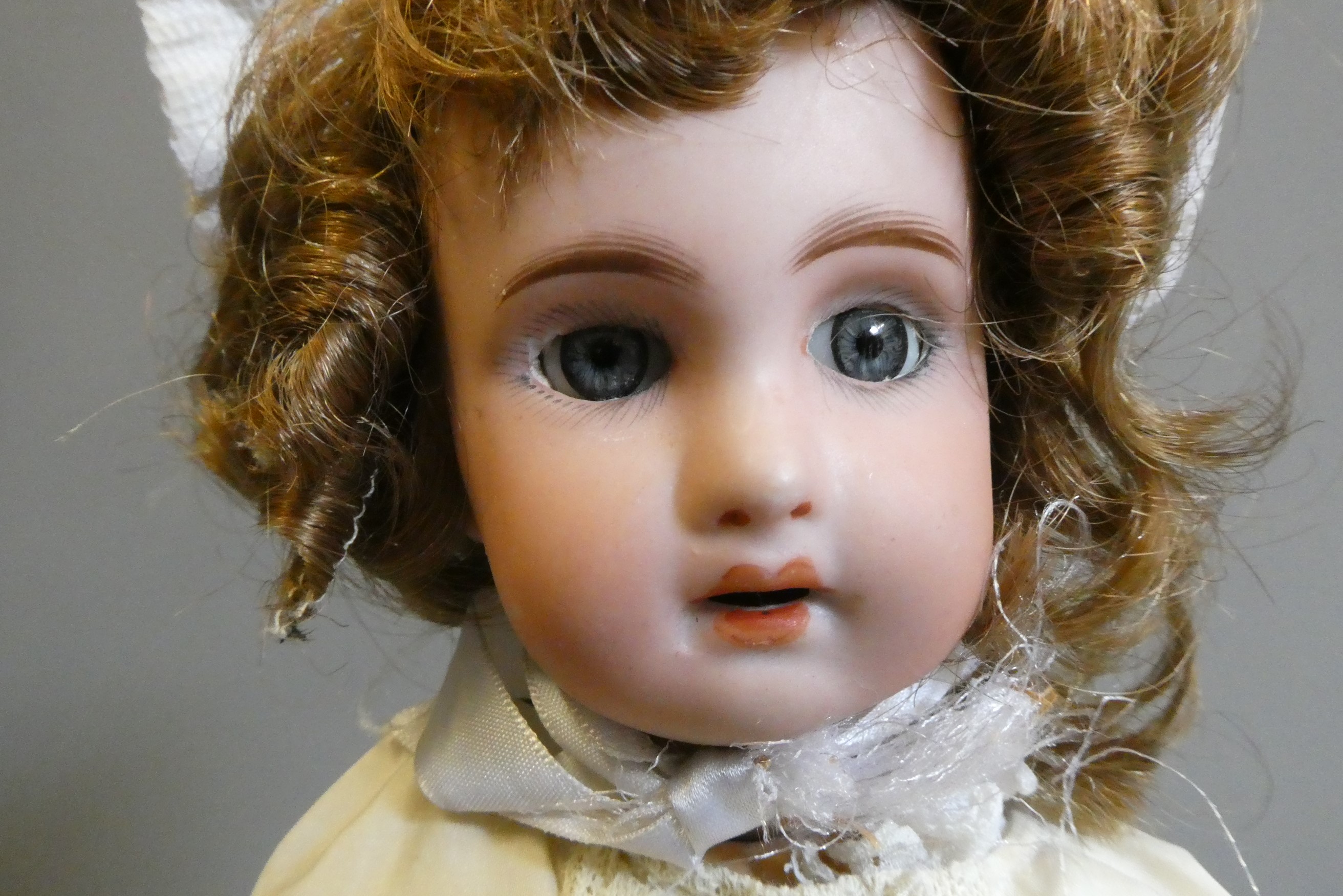 A French bisque socket head doll, with blue glass sleeping eyes, open mouth, teeth, pierced ears, Image