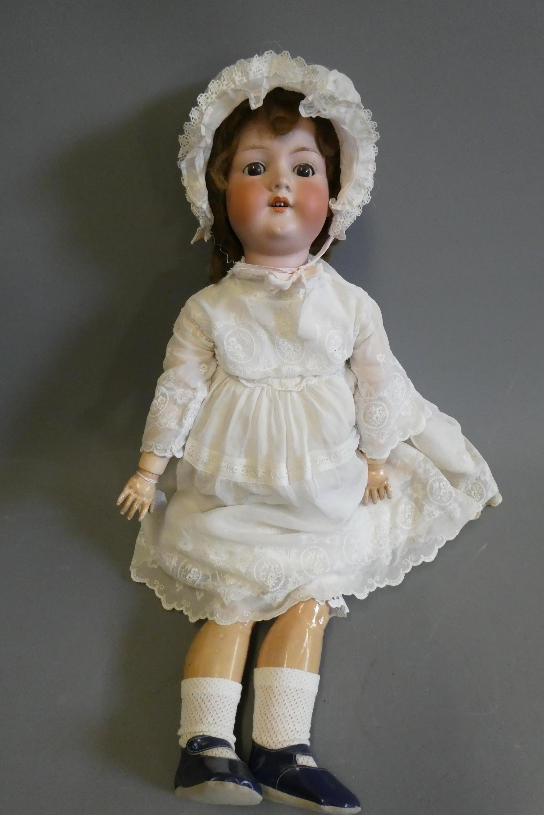 A large Armand Marseille bisque socket head doll, with brown glass sleeping eyes, open mouth, teeth, Image