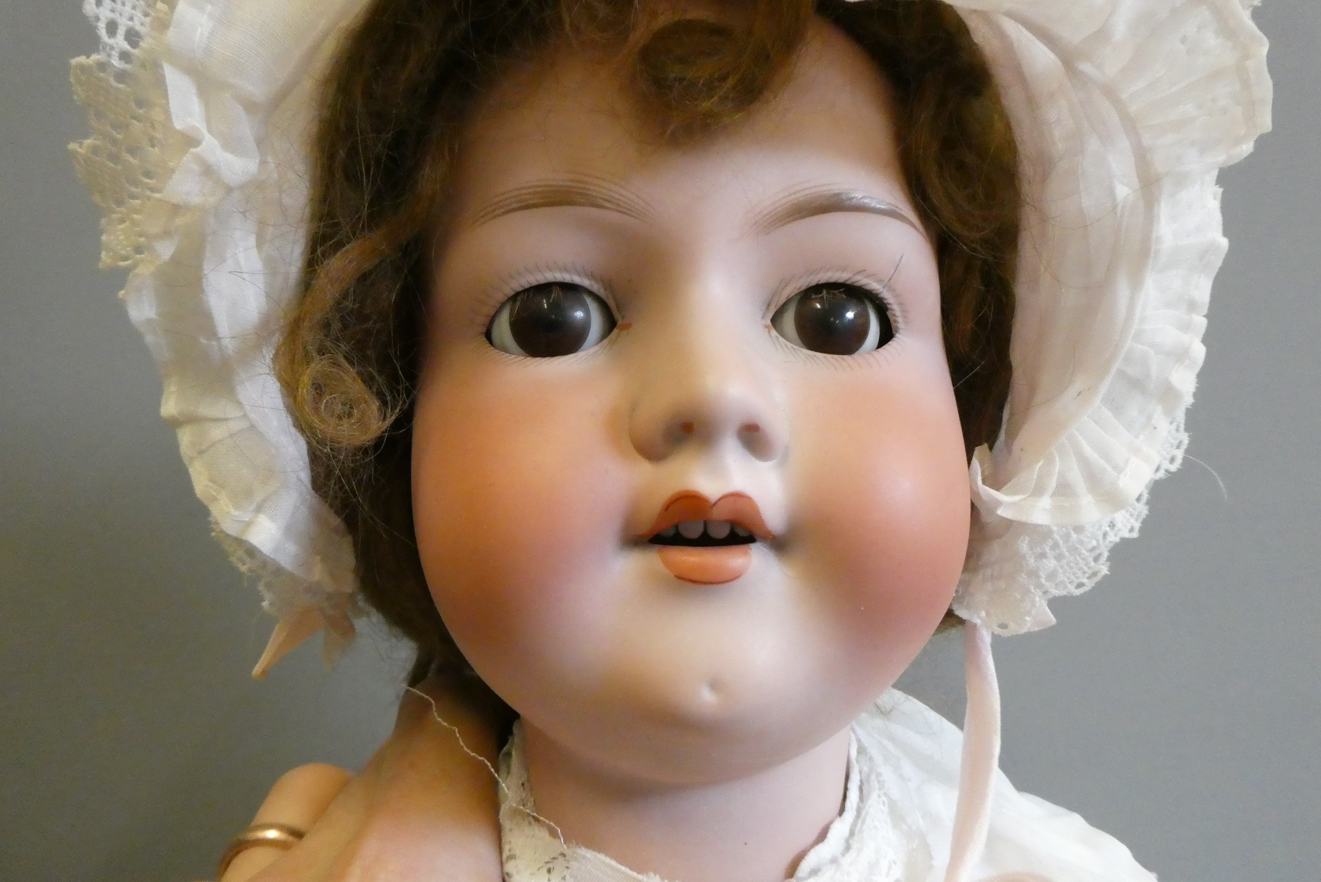 A large Armand Marseille bisque socket head doll, with brown glass sleeping eyes, open mouth, teeth, Image