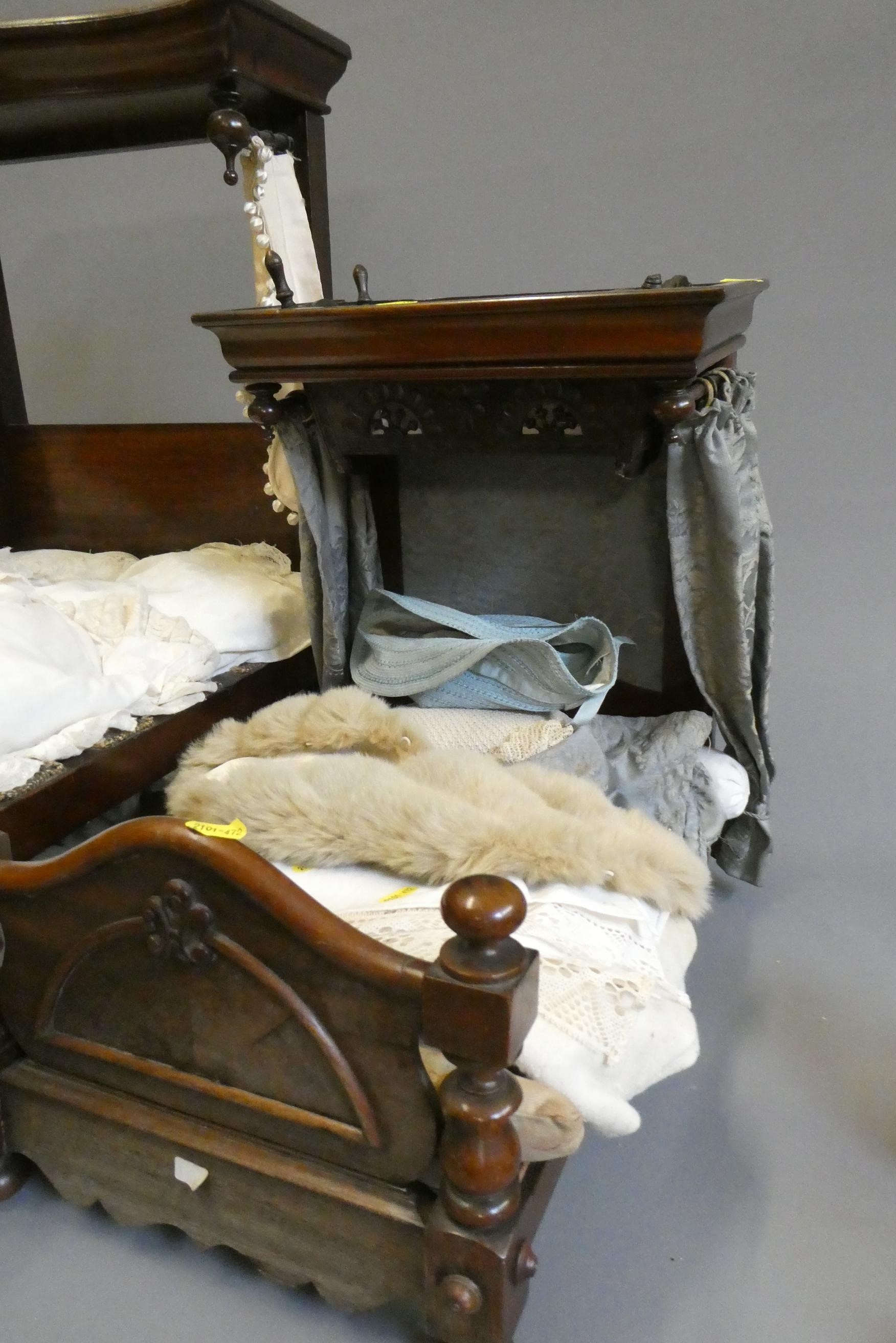 Three antique doll's beds, all of wood construction, comprising two half testers and one with turned Image