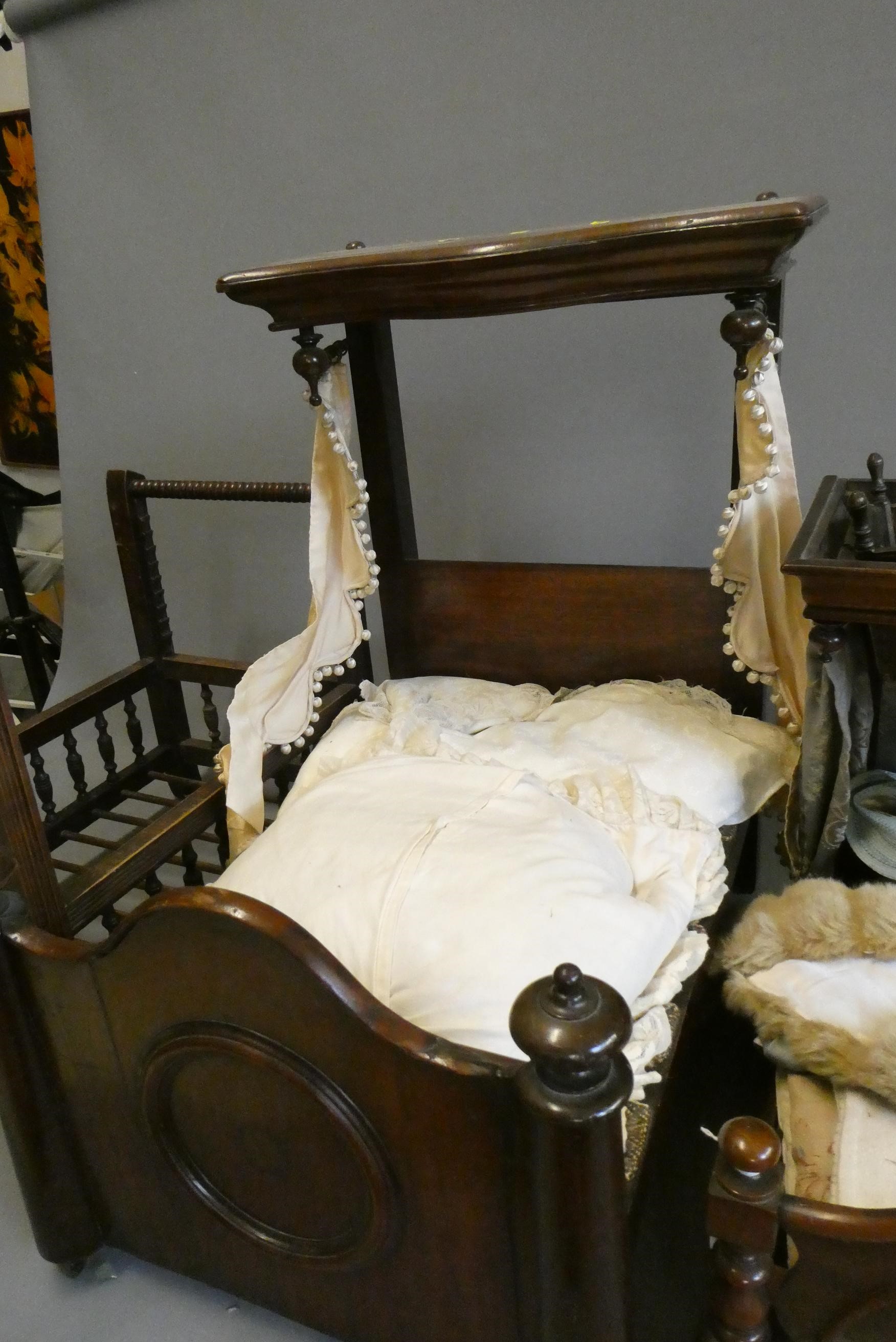 Three antique doll's beds, all of wood construction, comprising two half testers and one with turned Image