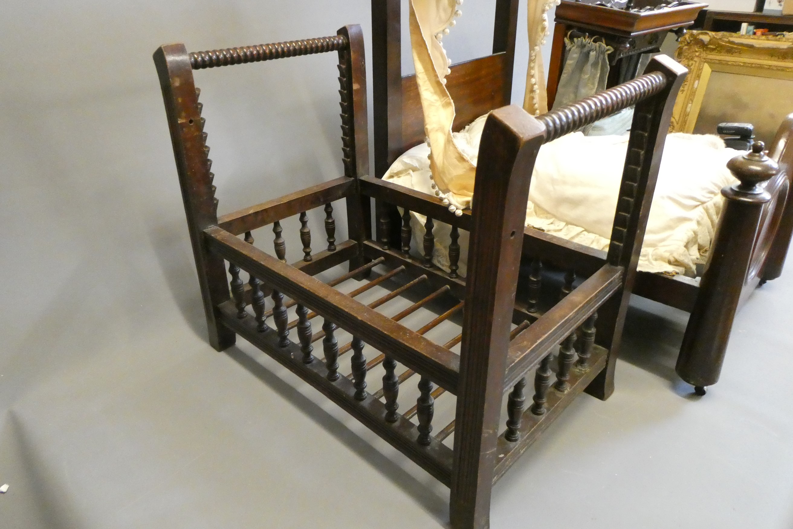 Three antique doll's beds, all of wood construction, comprising two half testers and one with turned Image