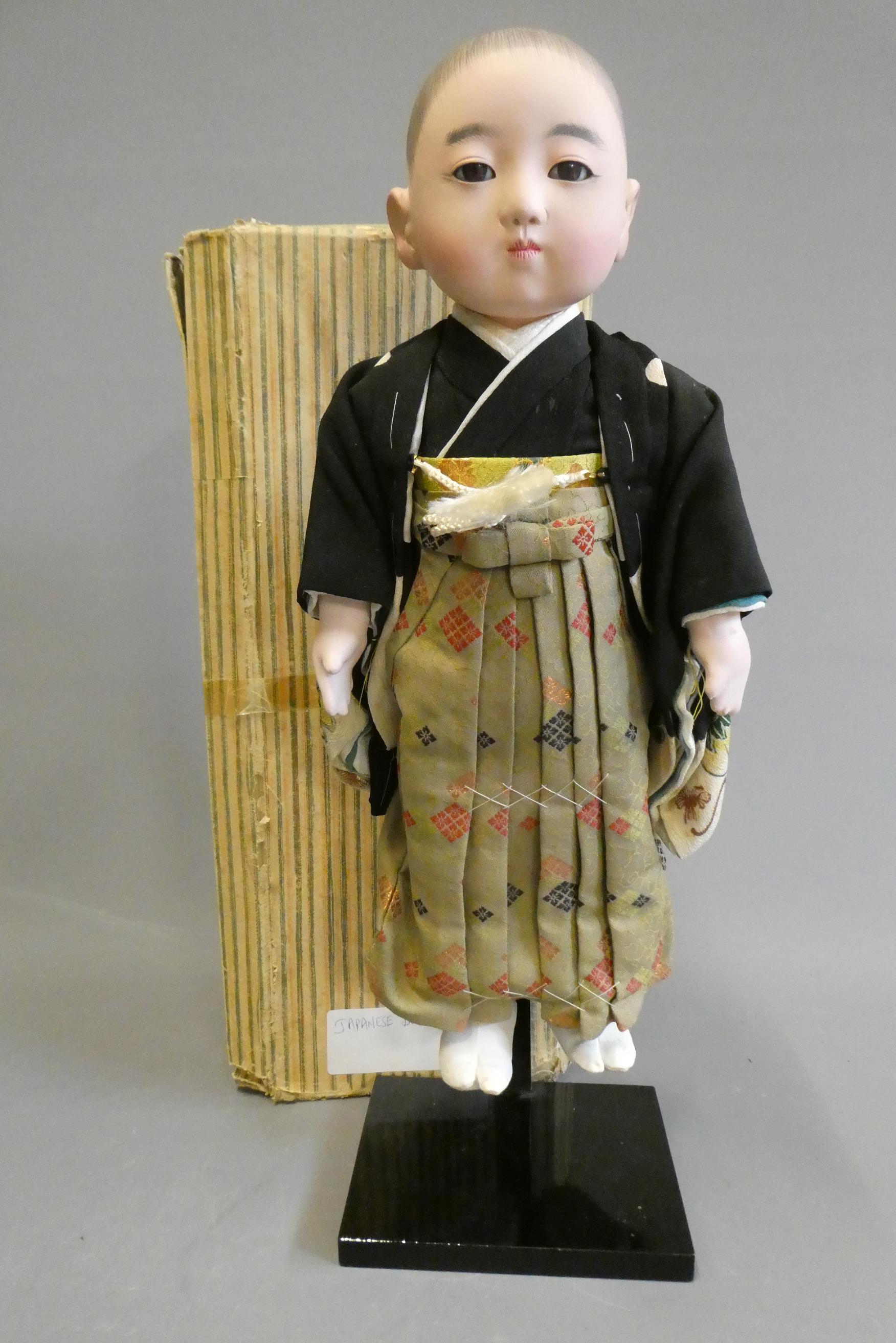 A Japanese doll, with composition head, glass fixed eyes, composition lower limbs, original outfit Image