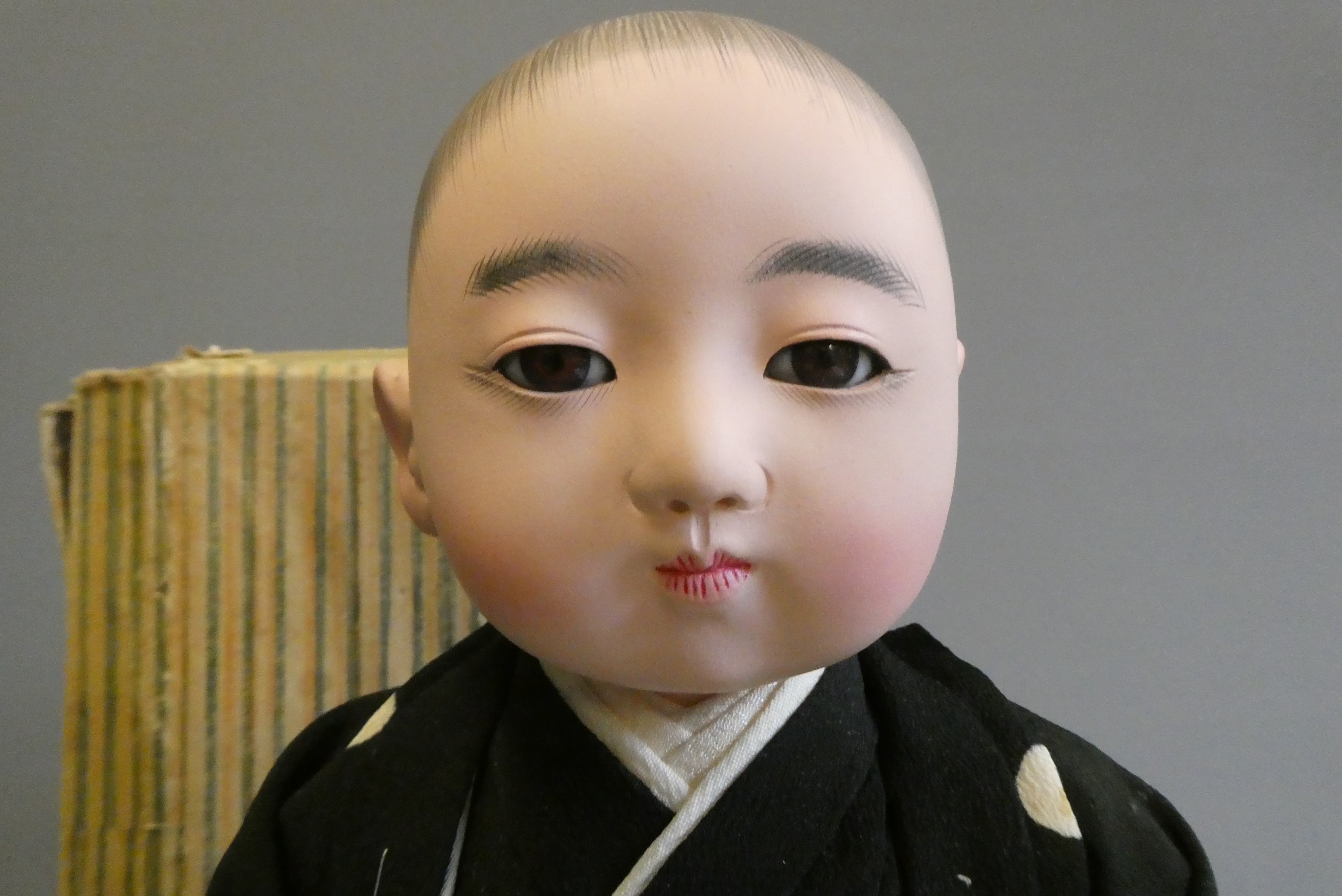A Japanese doll, with composition head, glass fixed eyes, composition lower limbs, original outfit Image