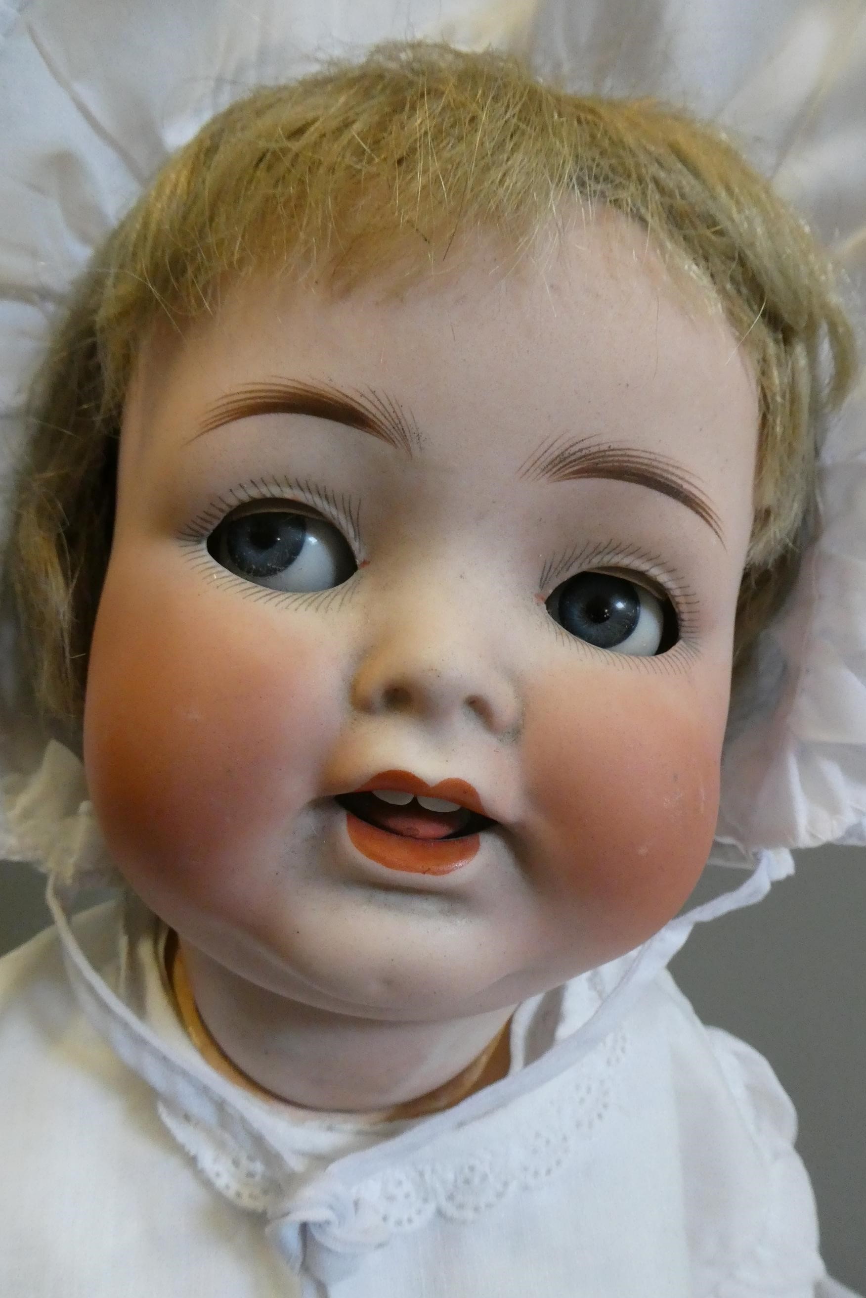 A Heubach Koppelsdorf bisque socket head flirty doll Image