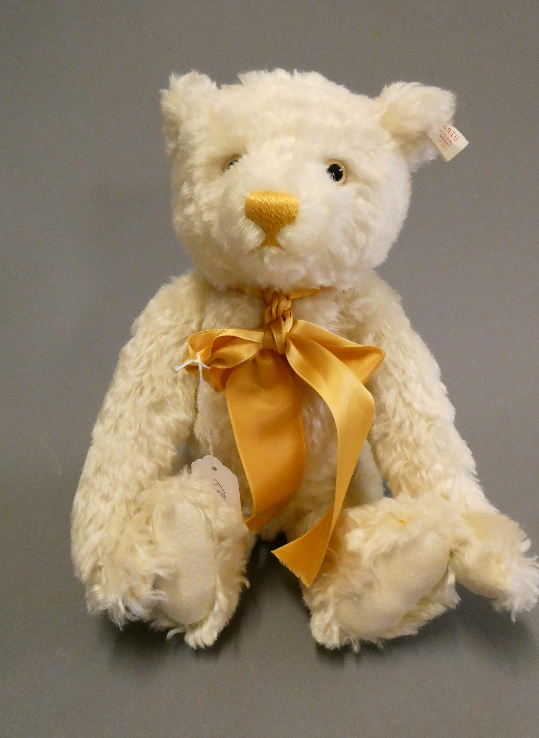 A white Steiff growling teddy bear, with gold sewn nose, matching bow, felt pads, ear stud and Image