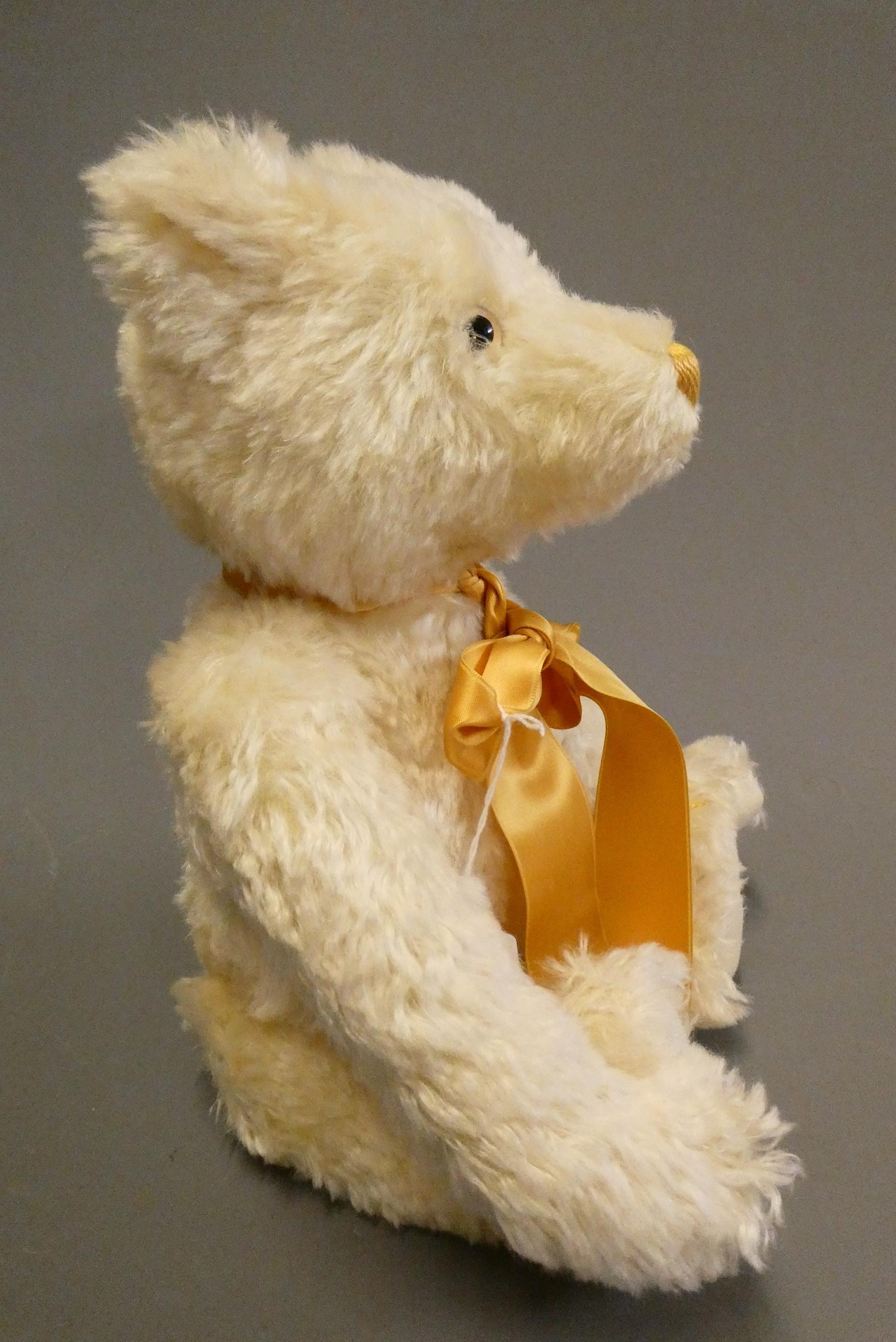 A white Steiff growling teddy bear, with gold sewn nose, matching bow, felt pads, ear stud and Image