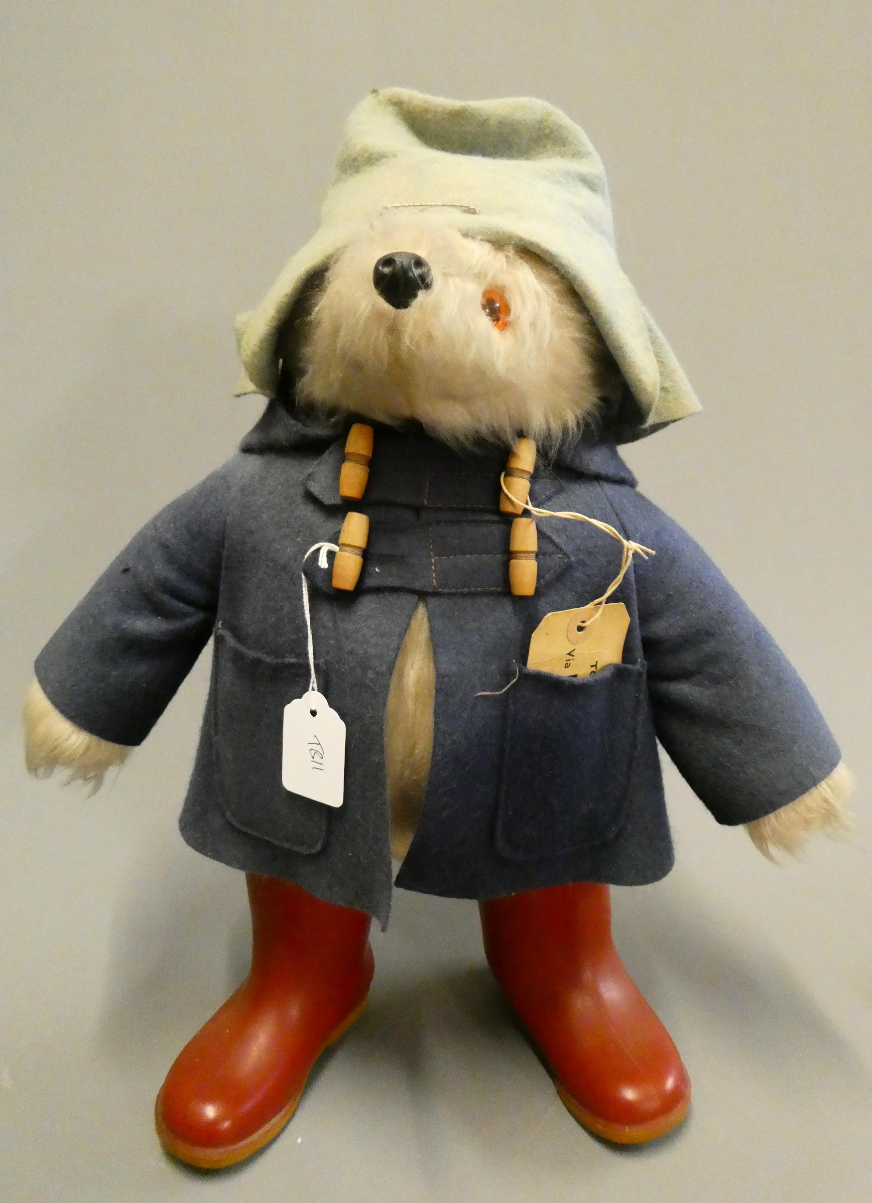 Vintage Paddington bear, with light blue felt hat, blue felt coat, red Dunlop boots and cardboard Image