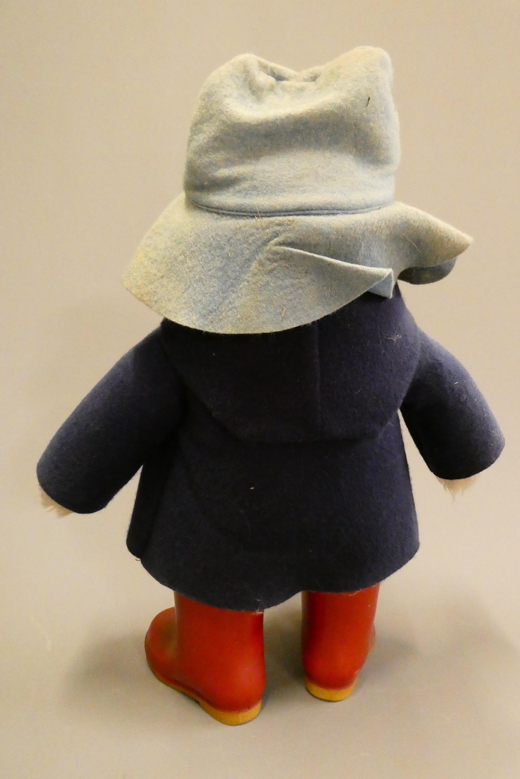 Vintage Paddington bear, with light blue felt hat, blue felt coat, red Dunlop boots and cardboard Image